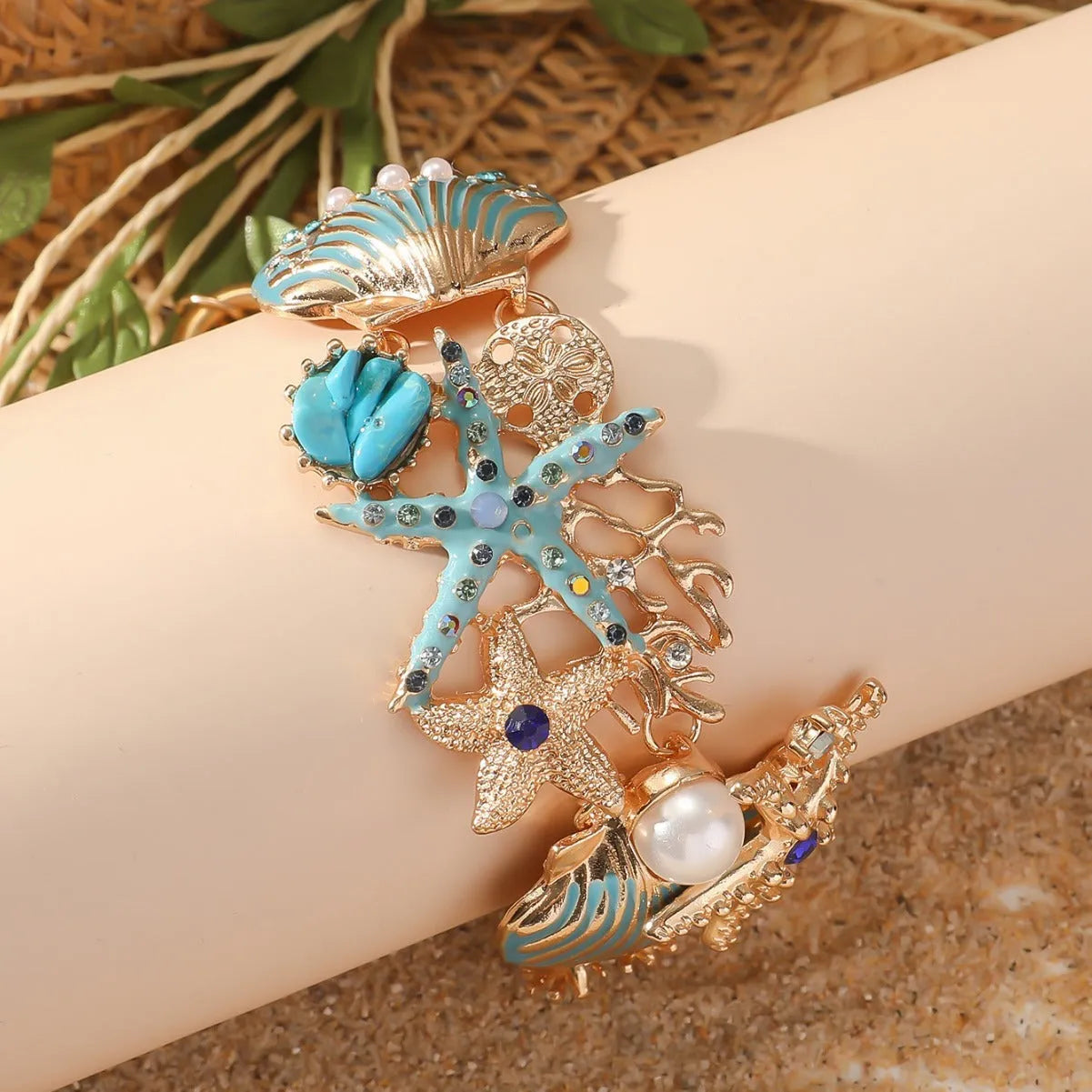 Women's alloy rhinestone bracelet with marine anchor, shell, star, and starfish motifs in blue, red, or turquoise.