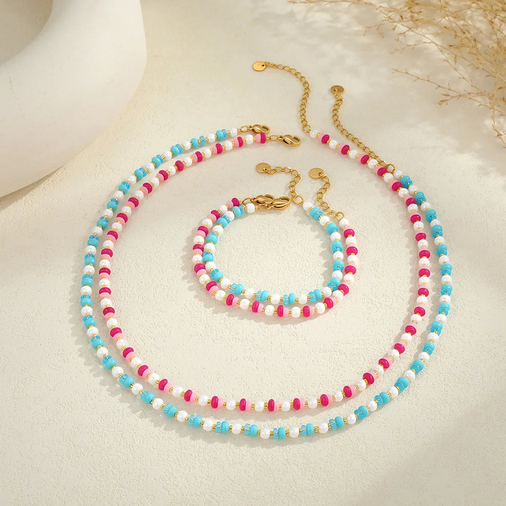 Sweet resin beaded necklace with geometric 18K stainless steel pendant, pink beads, and regular chain on light background