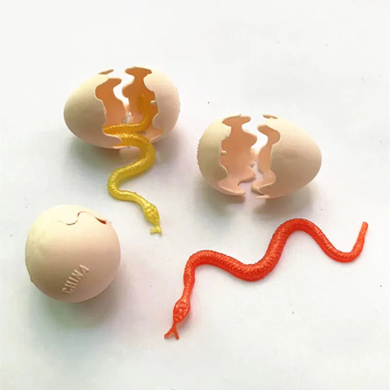Fake snake egg prank toy with plastic egg shell and stretchable snake on plain background