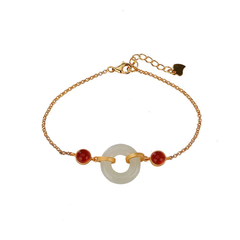 Gold-coloured women's bracelet with inlaid green Hetian jade stone and an adjustable peace buckle clasp.