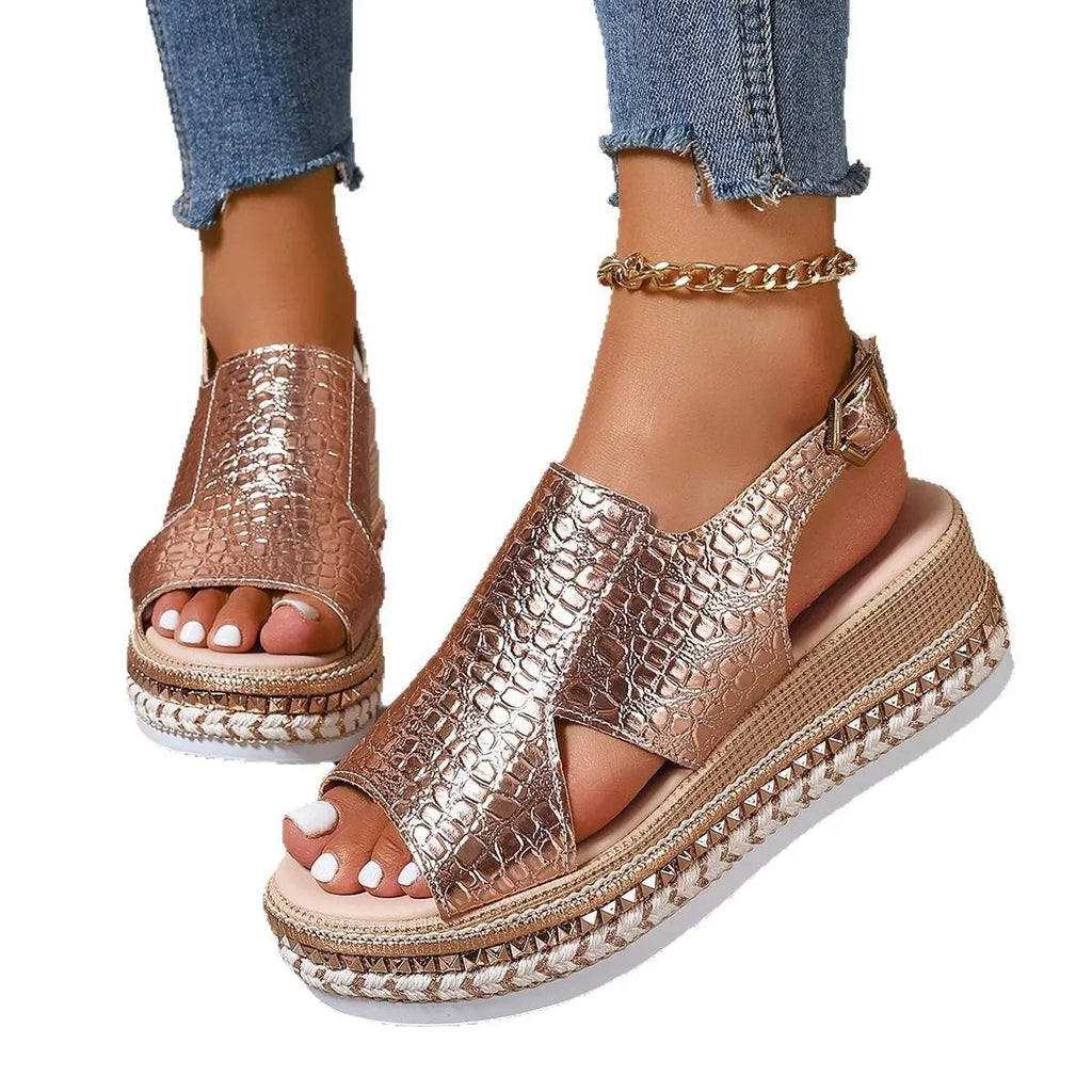 Gold women's Roman sandals with round toe, ankle buckle, and hollow-out design on a rubber sole.