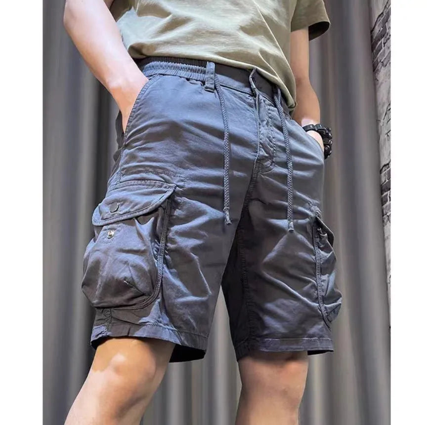 Loose straight-leg multi-pocket overalls in khaki, showing Korean-style casual fit.