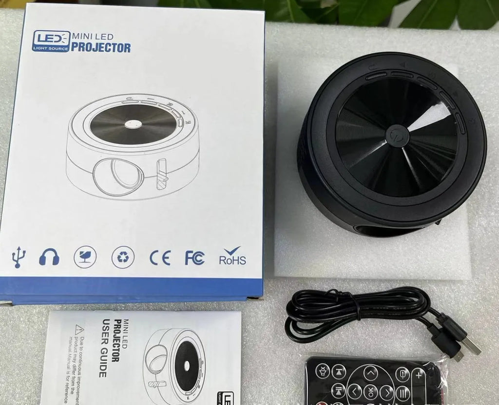 YT200 portable wired LED projector in black showing compact 110mm design with remote control