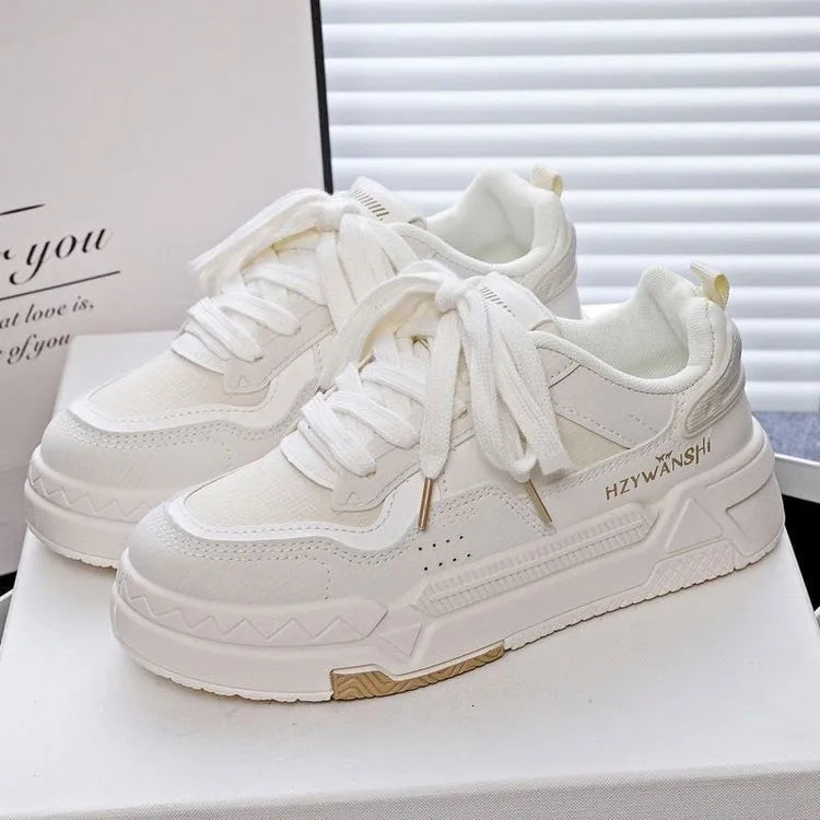 Beige children's board shoes with thick rubber sole, cross shoulder straps, and front lace-up closure on a white background.