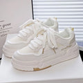 Beige children's board shoes with thick rubber sole, cross shoulder straps, and front lace-up closure on a white background.