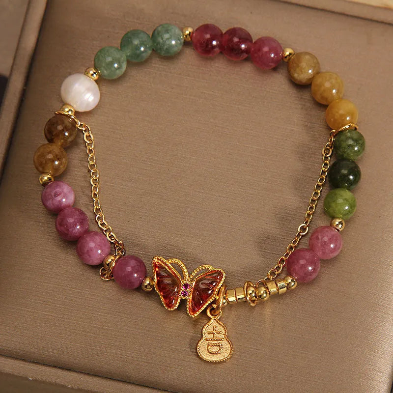 Women's tourmaline butterfly gourd bracelet with agate, showing jade coloured carved centrepiece.