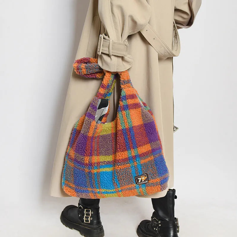 Women's plaid crossbody tote bag in soft plush fabric showing horizontal square shape and strapless shoulder strap