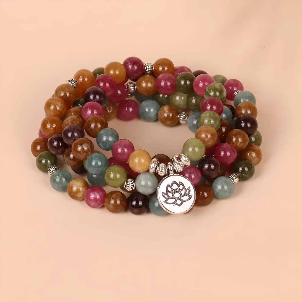 Tourmaline-colour alloy bracelet with 108 beads in a lotus string design laid flat