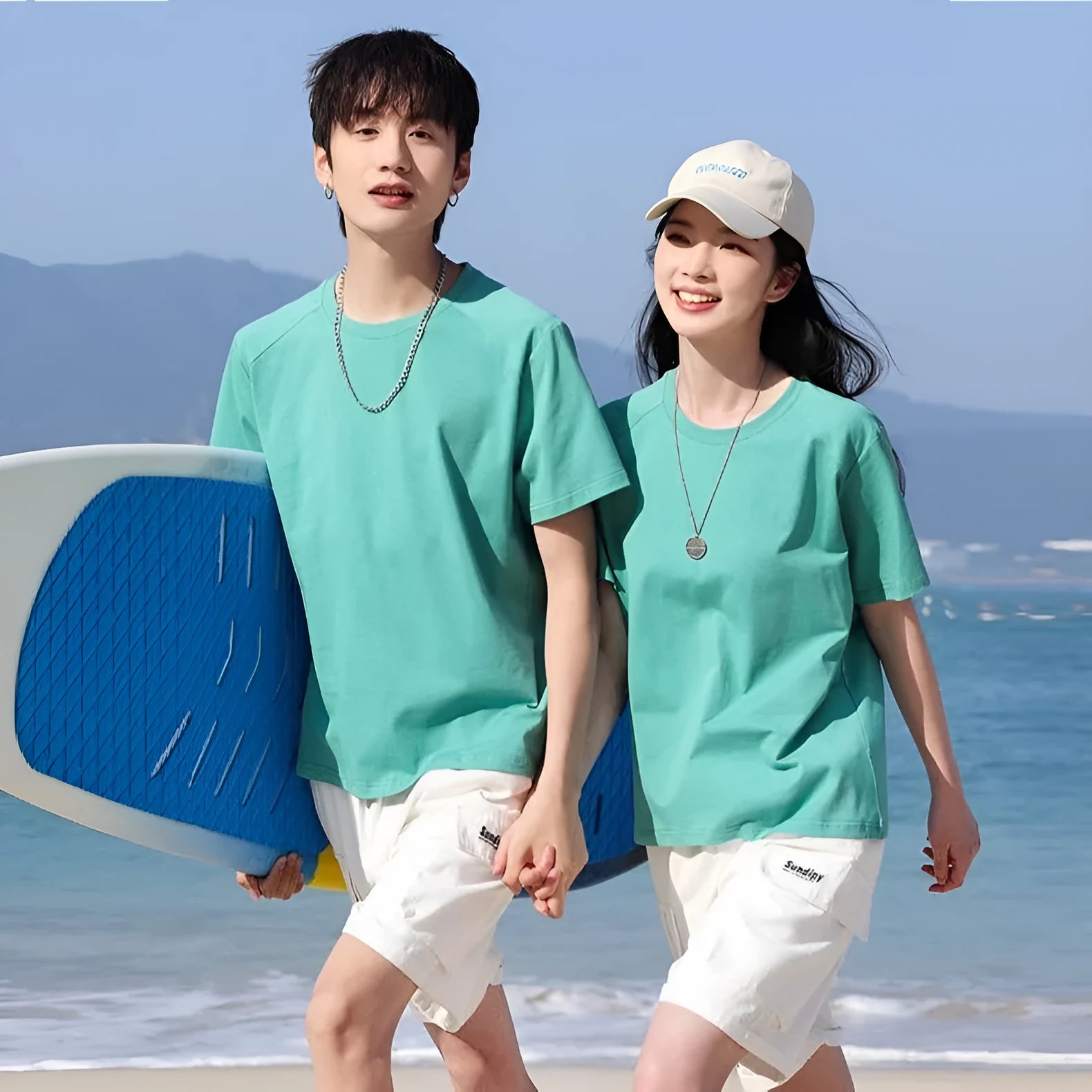 Men's solid colour cotton short sleeve t-shirt laid flat, showing colour options including black, white, and bright orange.