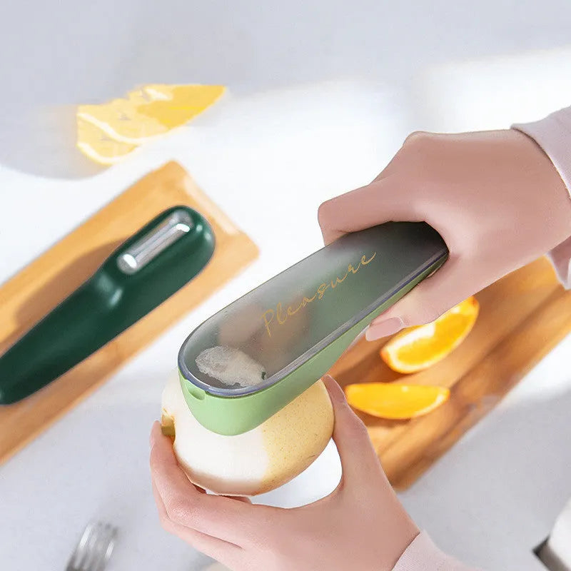Green plastic peeler with a stainless steel blade stored inside its own clear storage tube, showing the hanging hole on the handle.