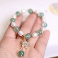 Green strawberry freshwater pearl bracelet with Chinese knot design and jade flower decorations