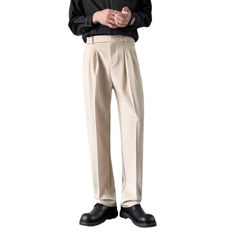Men's apricot and black straight leg loose fit trousers on a hanger, showing the polyester fabric.