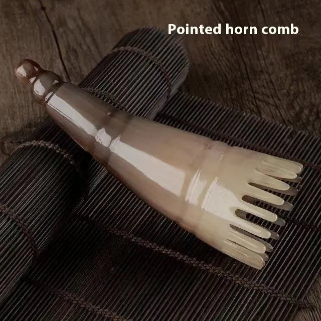 Black buffalo horn comb with wide teeth and pointed tip for shampoo application and head massage