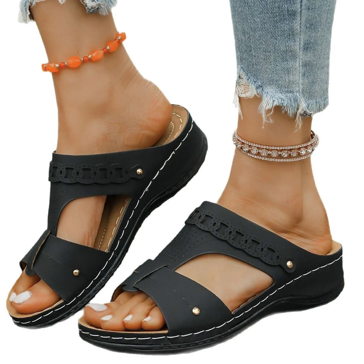 Women's blue Roman style slope heel slippers with fish mouth toe holder on a wooden floor.