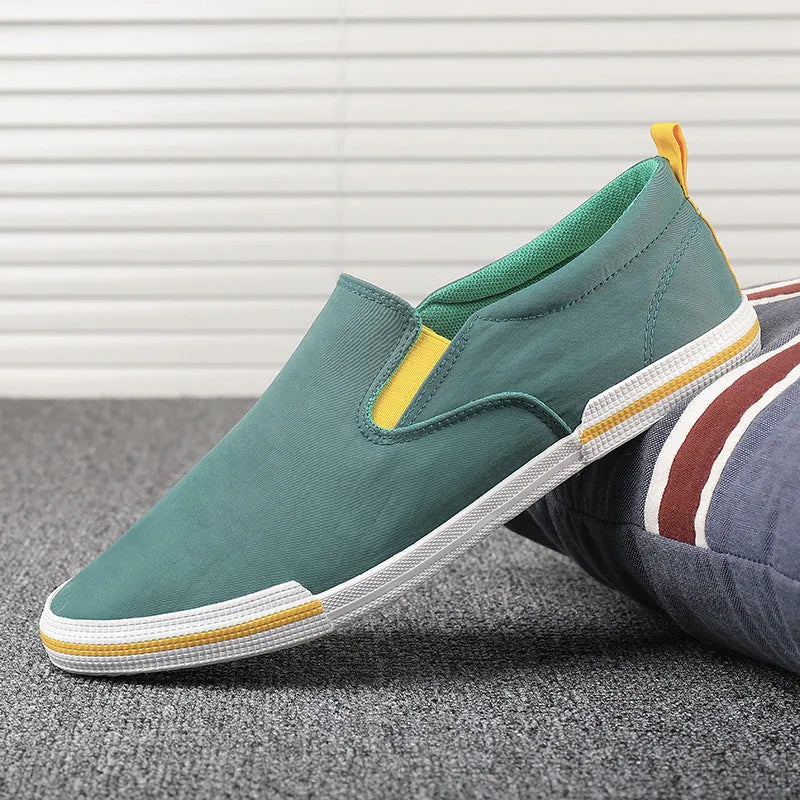 Men's low-top canvas sneakers in grey, black orange, and khaki colours with round toe and vulcanised rubber soles