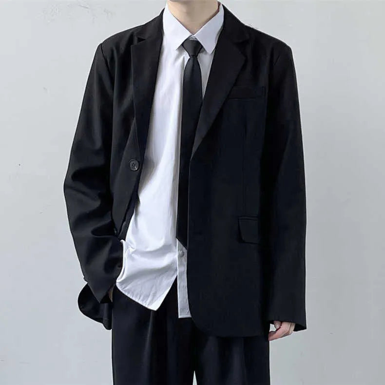 Plus size men in a navy college style suit set with white shirt and tie, showing loose fit.