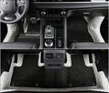 Mitsubishi Outlander full surround floor mats in black, fitted in a car footwell.
