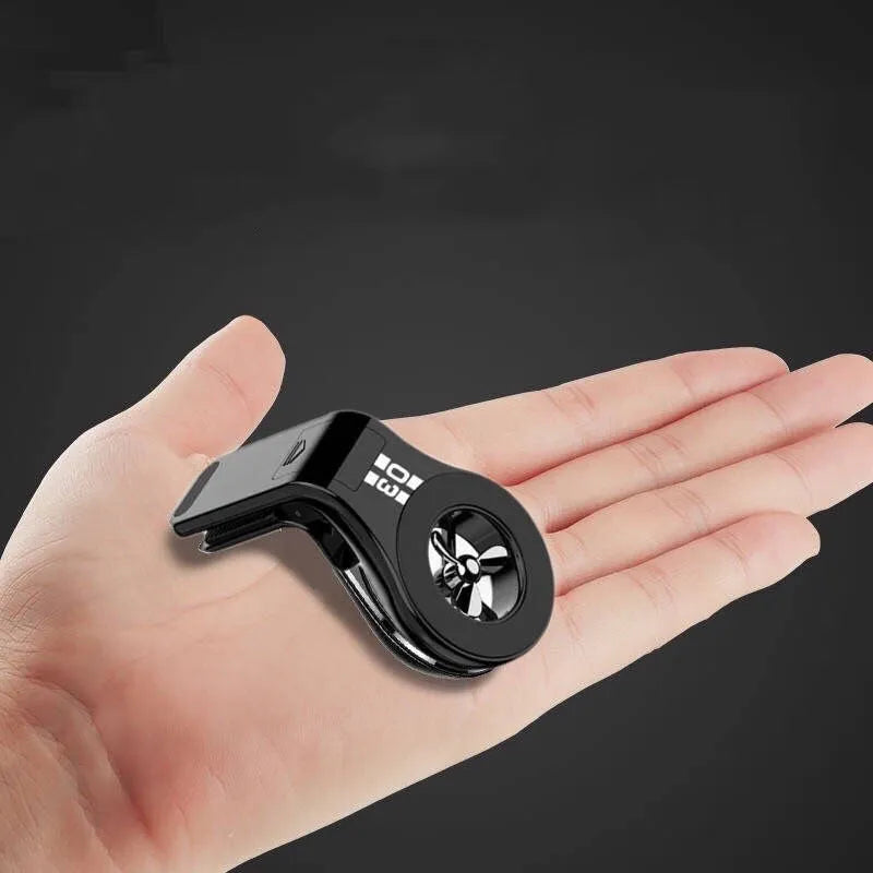 Black magnetic car air vent phone holder with adjustable head and fragrance slices attached to a vehicle vent.