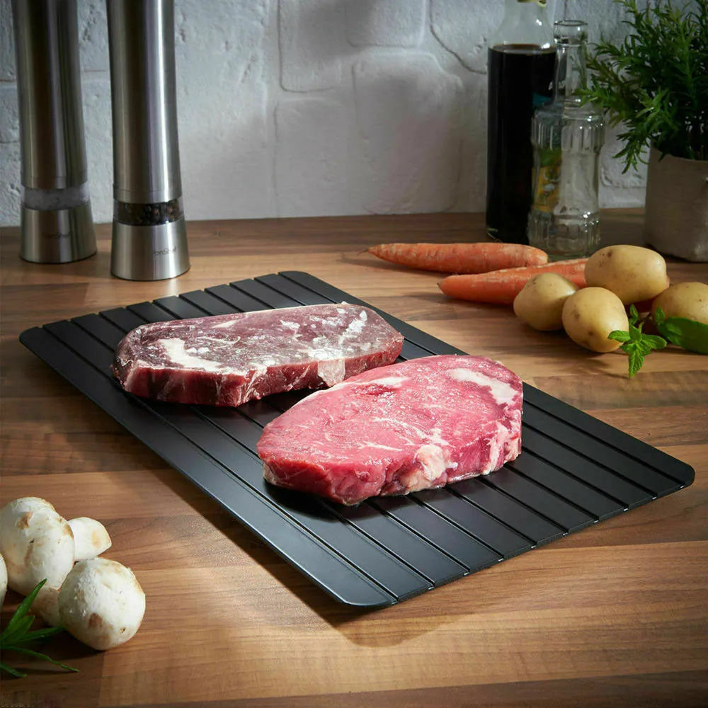 Black rectangular aluminium fast defrost tray for thawing frozen meat and food