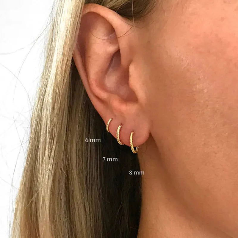 Sterling silver twisted round ring earrings in gold or white gold finish, shown in 6mm, 7mm, 8mm, and 13mm sizes.