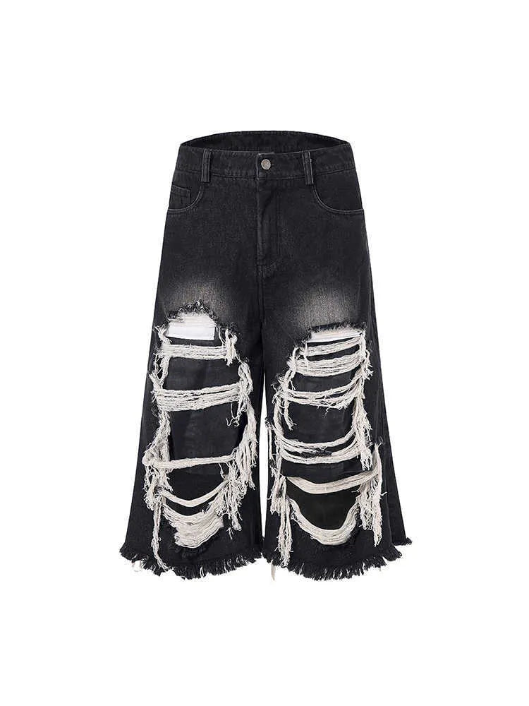 Black women's cropped wide-leg jeans with ripped patch detail on mid-high waist.