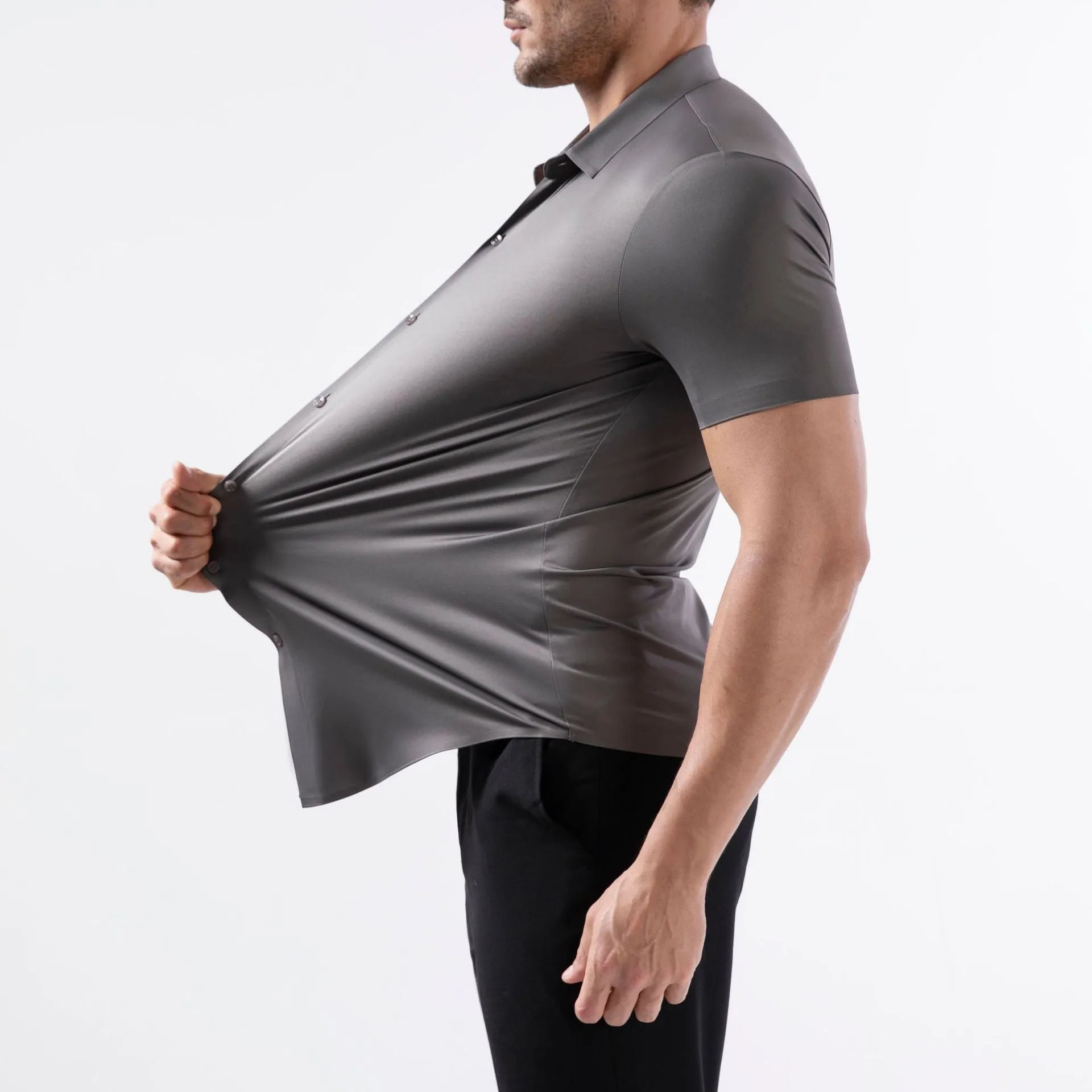 Man wearing a grey short sleeve cardigan-style shirt made from elastic non-iron fabric.