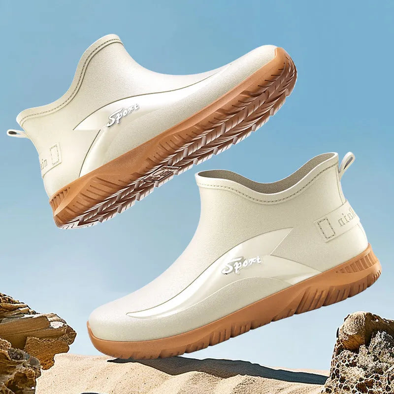 Men's short PVC wellington boots in beige and black colours with a flat non-slip sole.