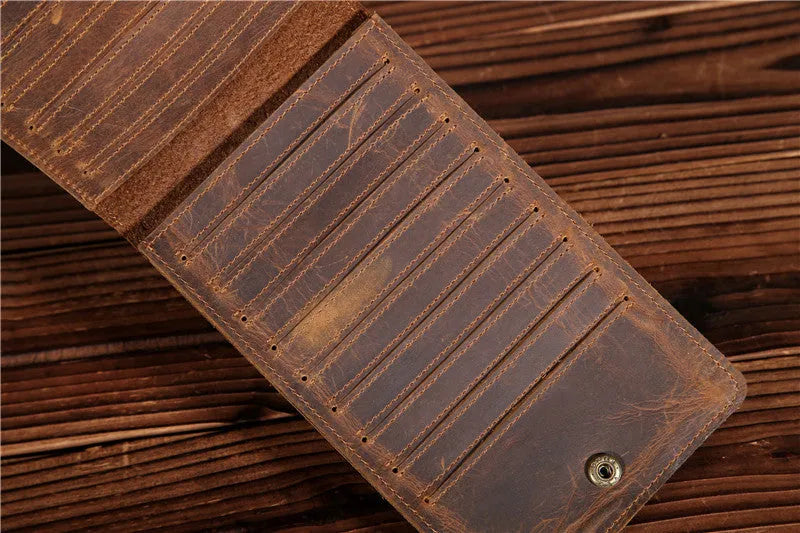 Men's long leather wallet open showing 18 card slots, cash compartment, and phone pocket.