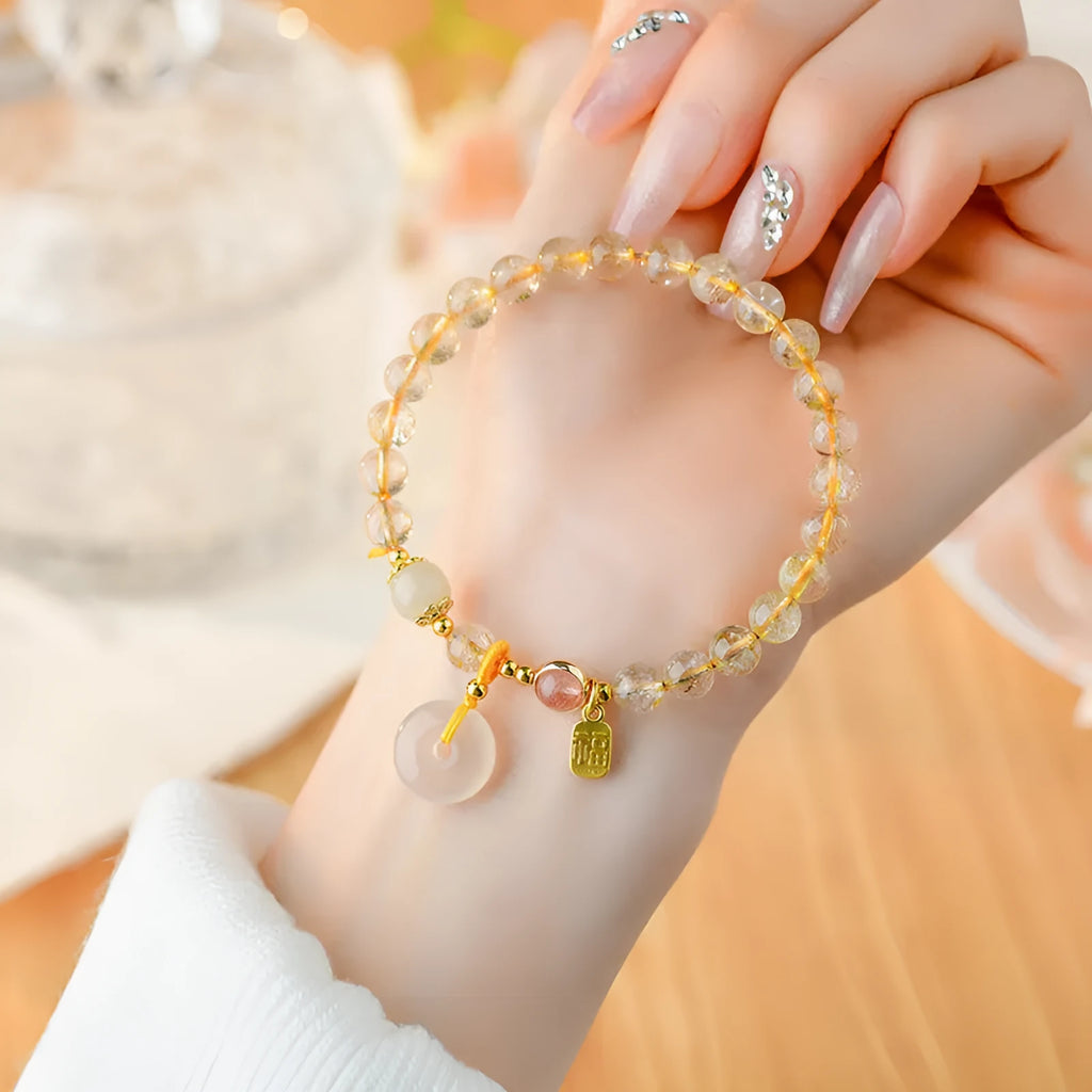 Gold rutilated quartz crystal bracelet with safety buckle and geometric blessing card pendant