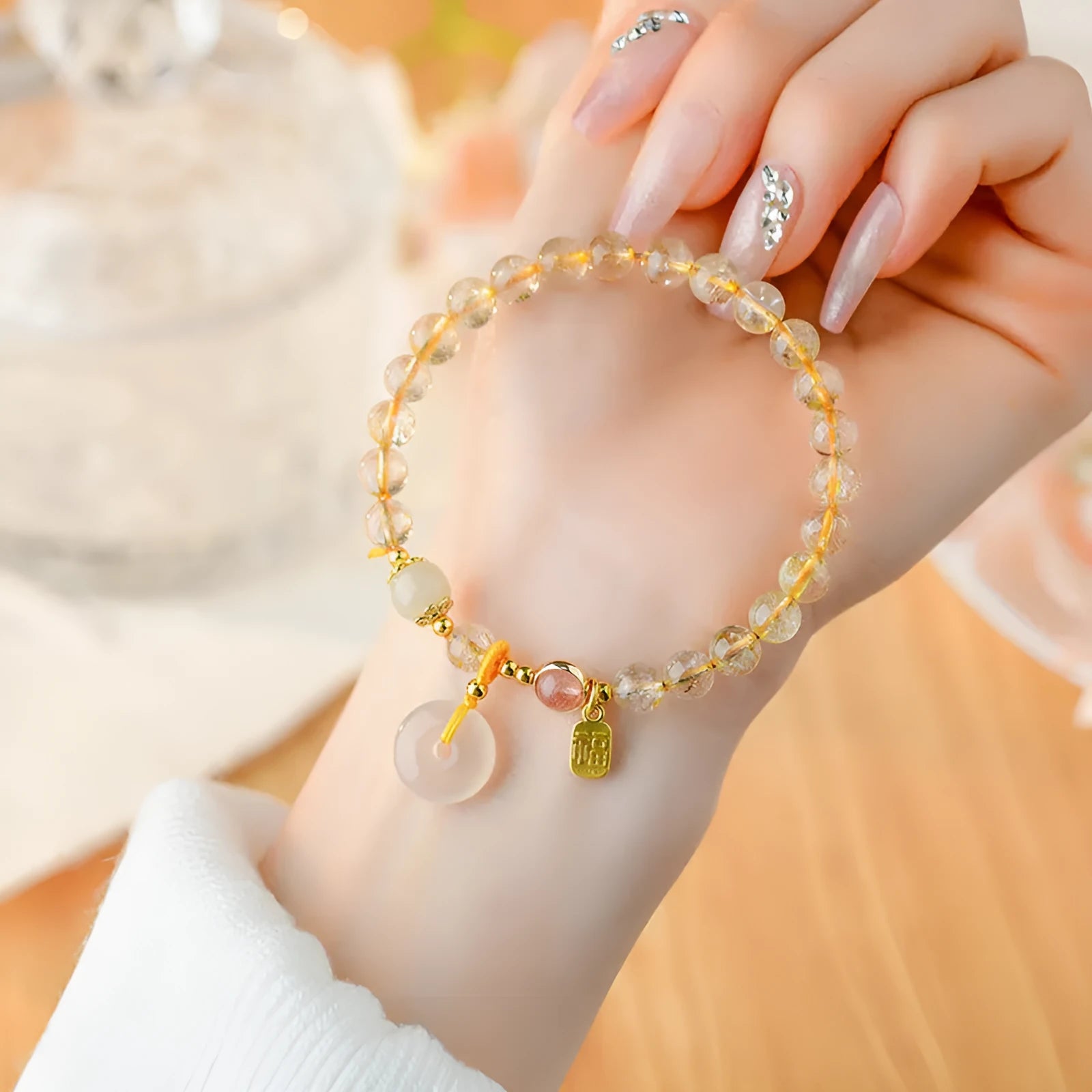 Gold rutilated quartz crystal bracelet with safety buckle and geometric blessing card pendant