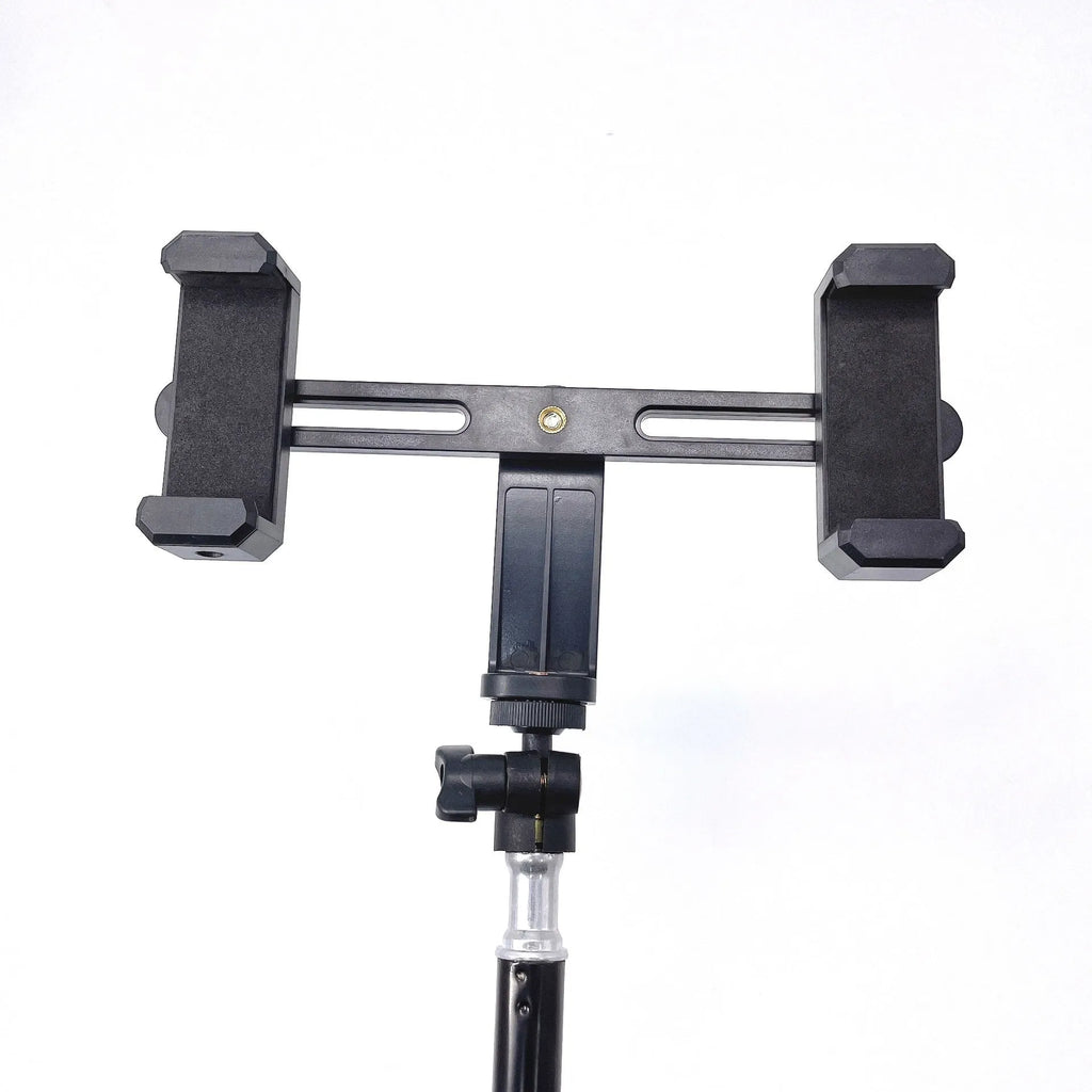 Black mobile phone tripod extended to 1.1m on a desk showing metal legs and phone mount