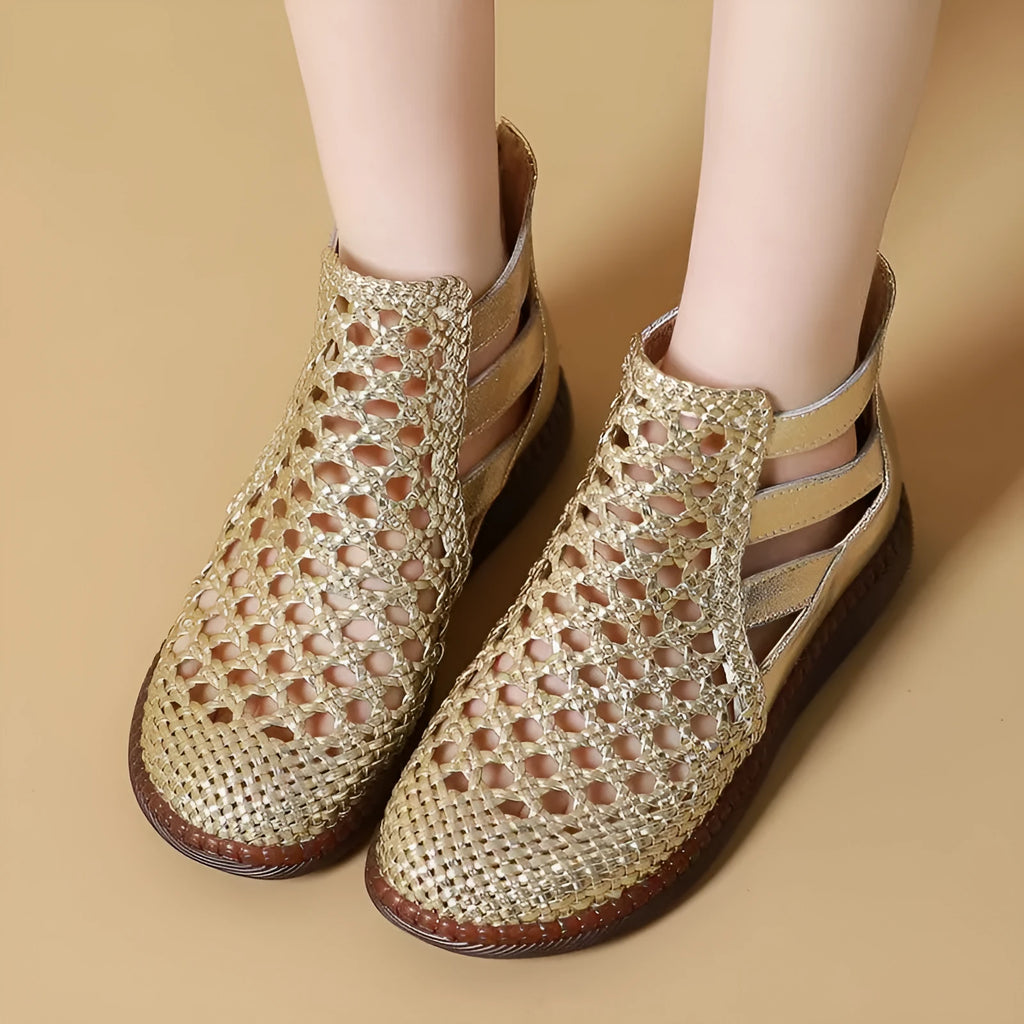 Women's flat gold sandals with hollow-out design and soft sole.