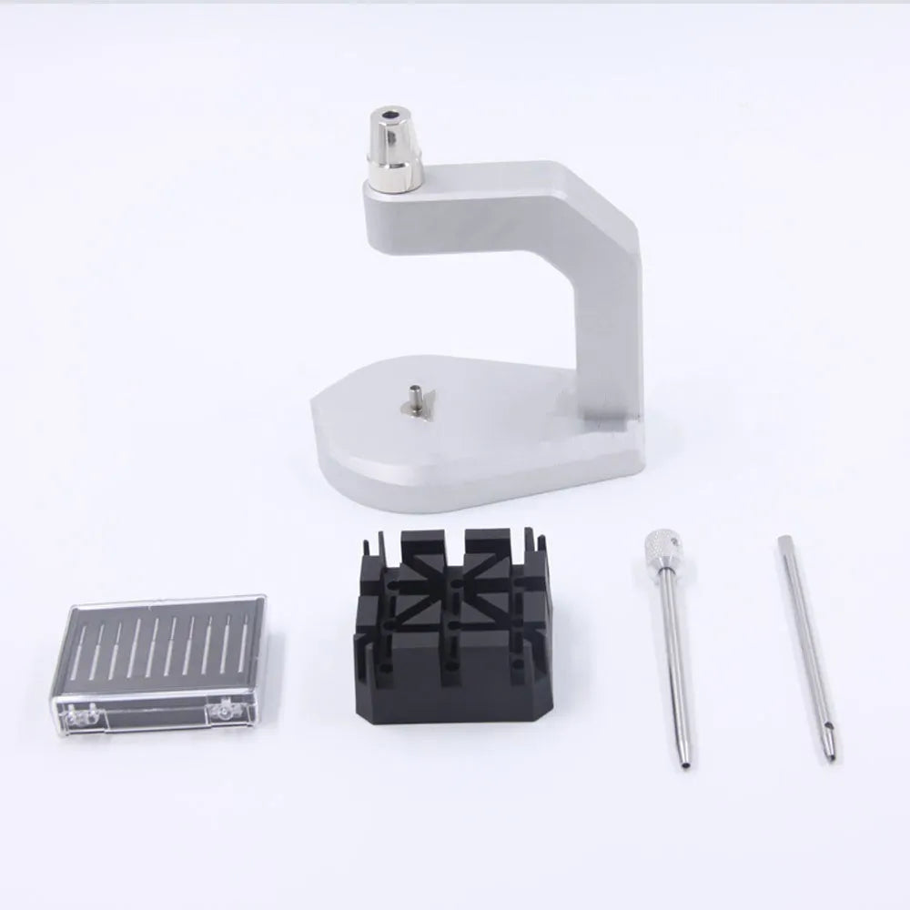 Silver tool steel press strap removal tool for watch and jewellery repair on a workbench.