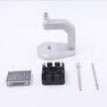 Silver tool steel press strap removal tool for watch and jewellery repair on a workbench.