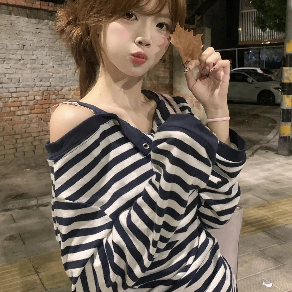 Dark blue women's oversized long sleeve t-shirt with stripes and embroidery detail.