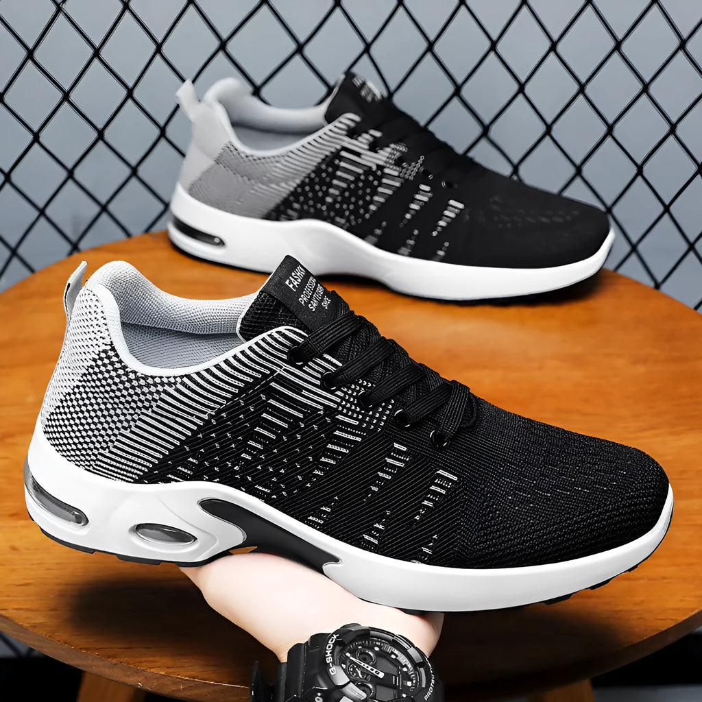 Men's low-top Flyknit mesh sneaker in black and grey colour with lace-up front and soft sole.