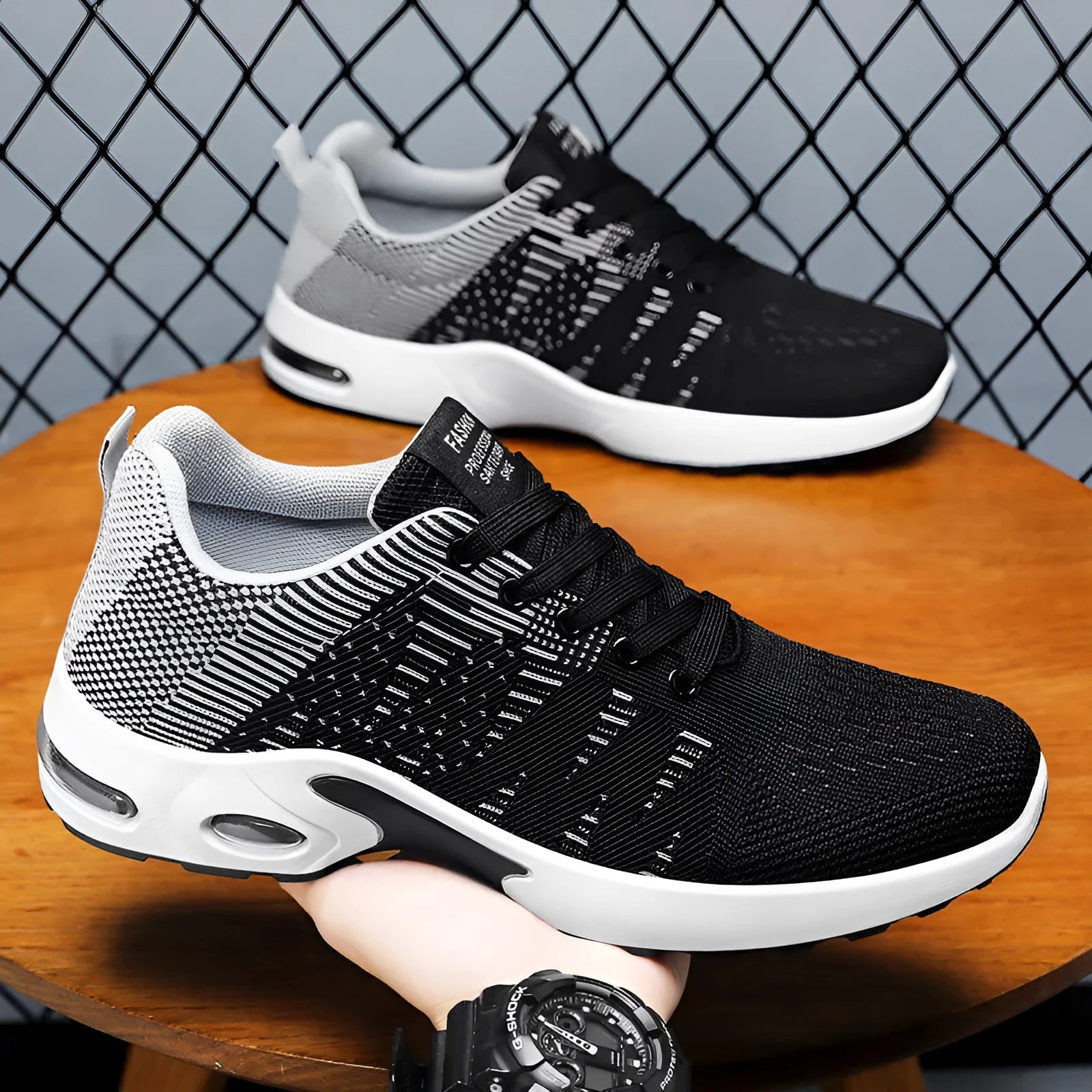 Men's low-top Flyknit mesh sneaker in black and grey colour with lace-up front and soft sole.