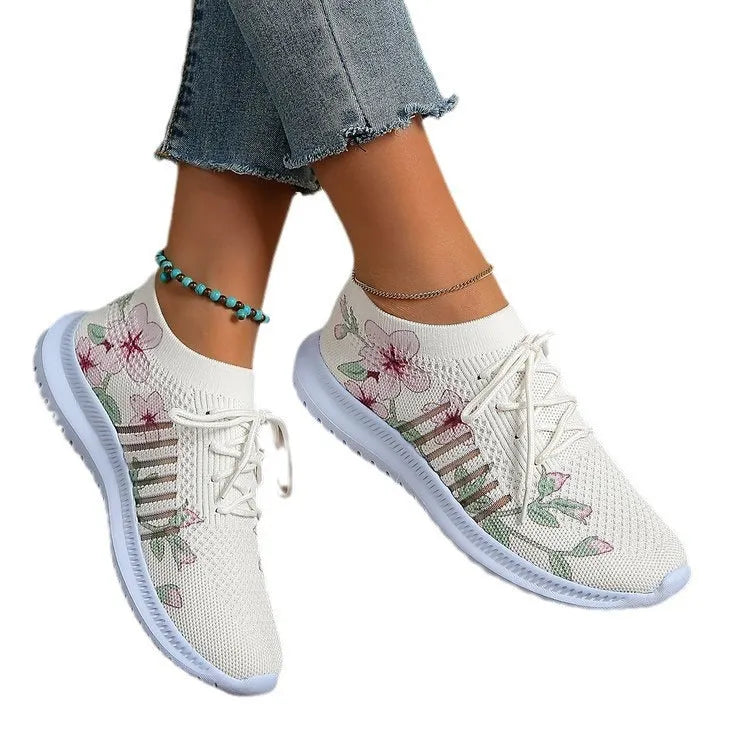 Women's Milky White mesh flyknit running shoes with round toe and rubber sole on a flat surface.