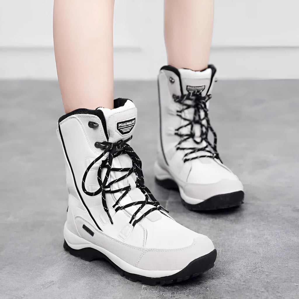 Women's black mid-calf length genuine leather snow boots with a round toe and rubber sole.