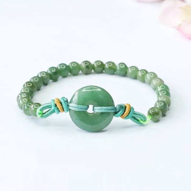 Oil green jade bracelet with star-shaped beads and a silver safety buckle clasp.
