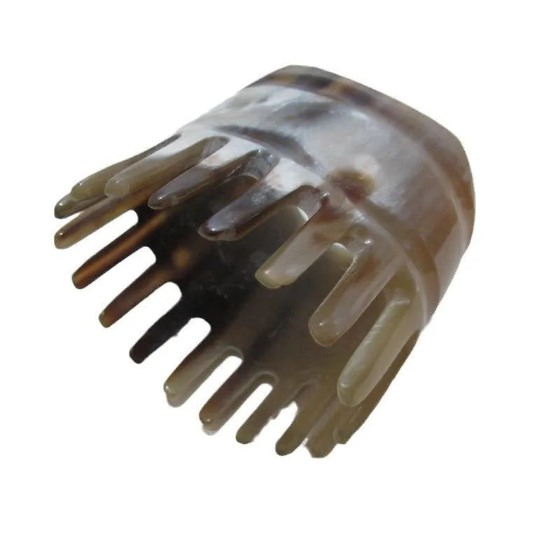 Black buffalo horn comb with wide teeth and pointed tip for shampoo application and head massage