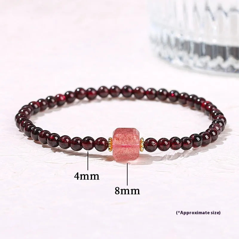 Geometric square garnet bracelet with carved Pixiu and strawberry quartz accents on a purple sand background.