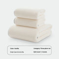 Three-piece coral fleece towel set in vanilla colour with one bath towel and two hand towels on a white background