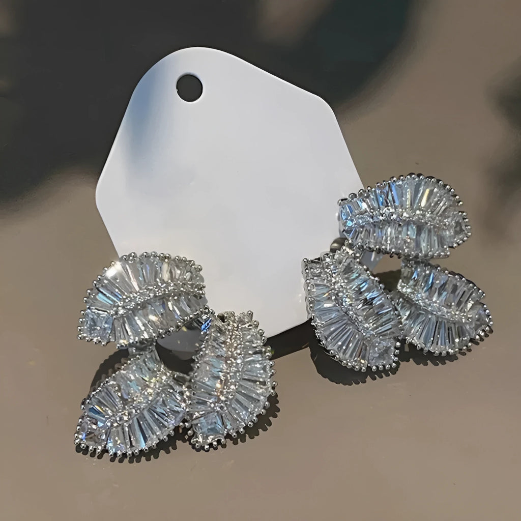 Leaf shaped zircon earrings in white gold colour with copper base and quadrilateral inlay