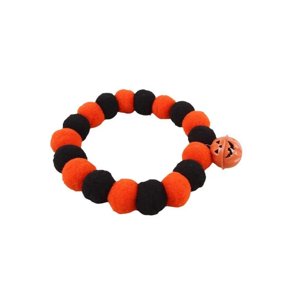 Orange pumpkin-patterned adjustable cat collar for Halloween worn by a cat.