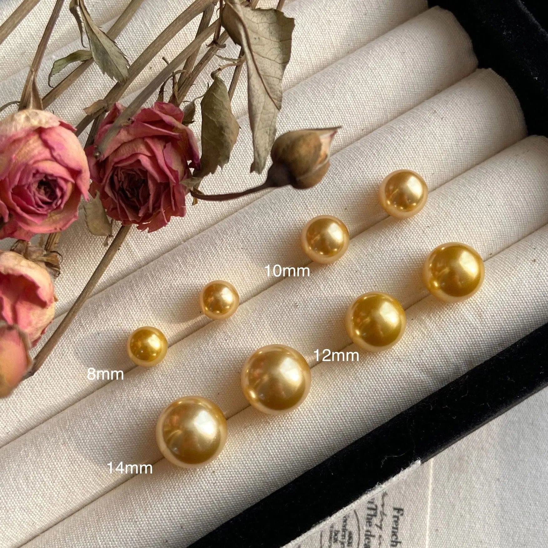 Large pearl stud earrings with geometric silver settings and eight-pointed star motifs