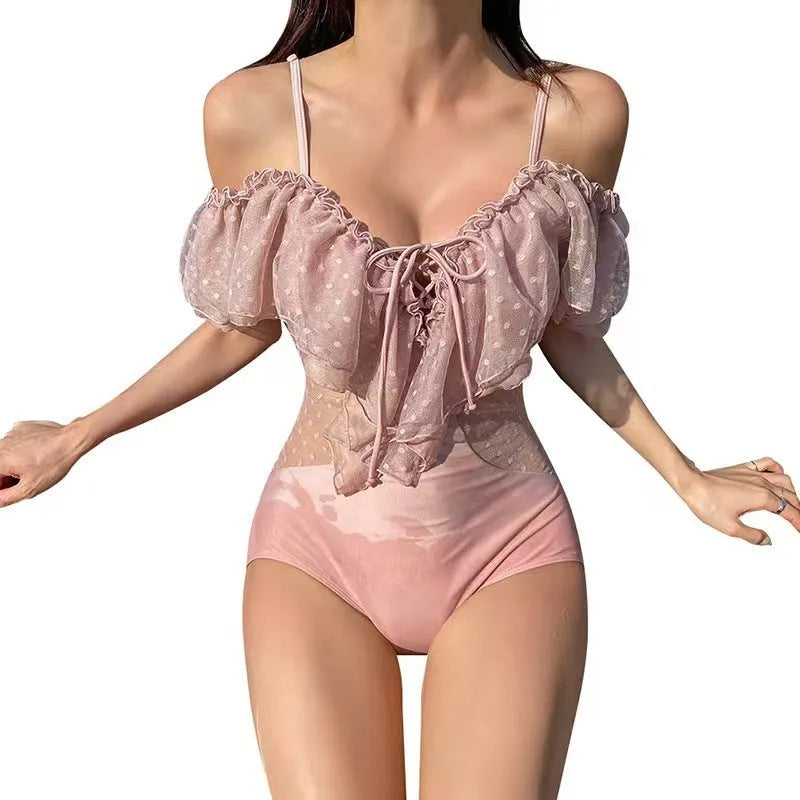 Pink solid-colour women's one-piece swimsuit on mannequin showing front view