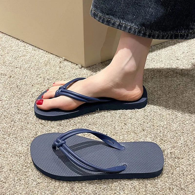 Men's casual PVC flip flops in beige with toe-covering design and textured non-slip sole.