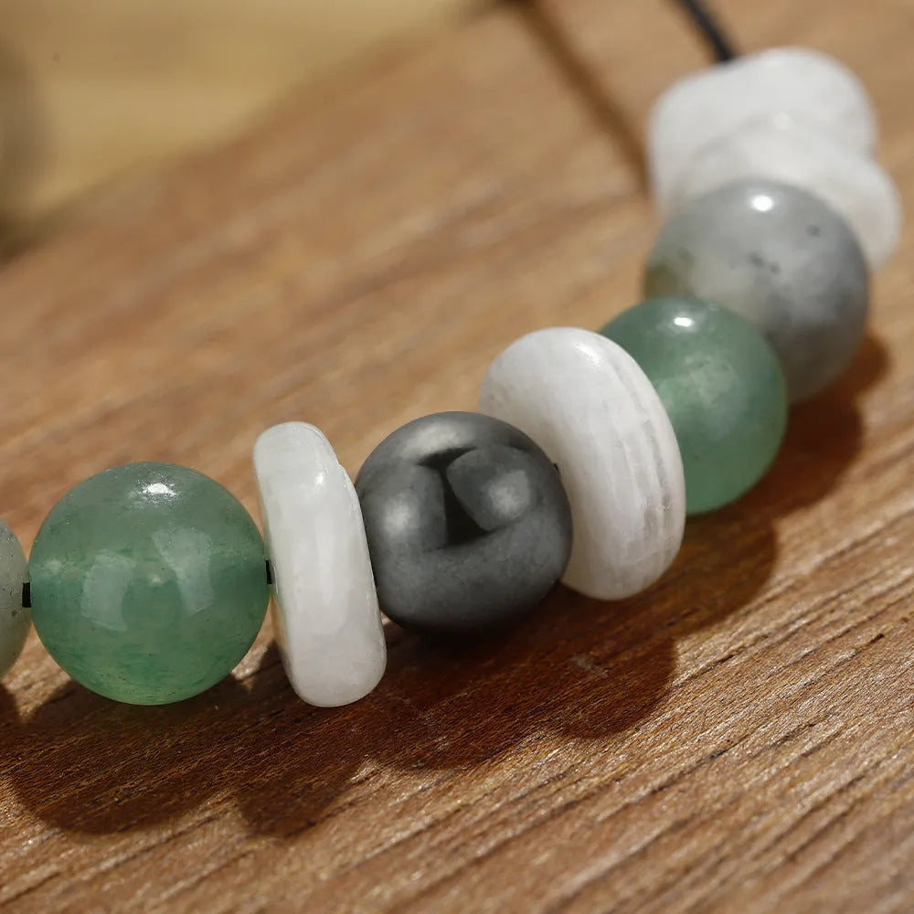 Women's geometric stone bead bracelet in earthy colours on a wrist, showcasing angular bead shapes.