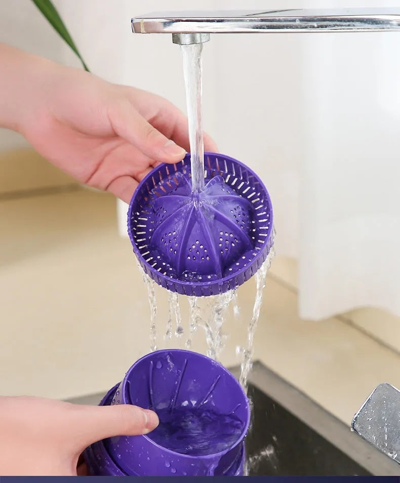 Purple USB rechargeable electric citrus juicer with detachable jug on a kitchen counter.